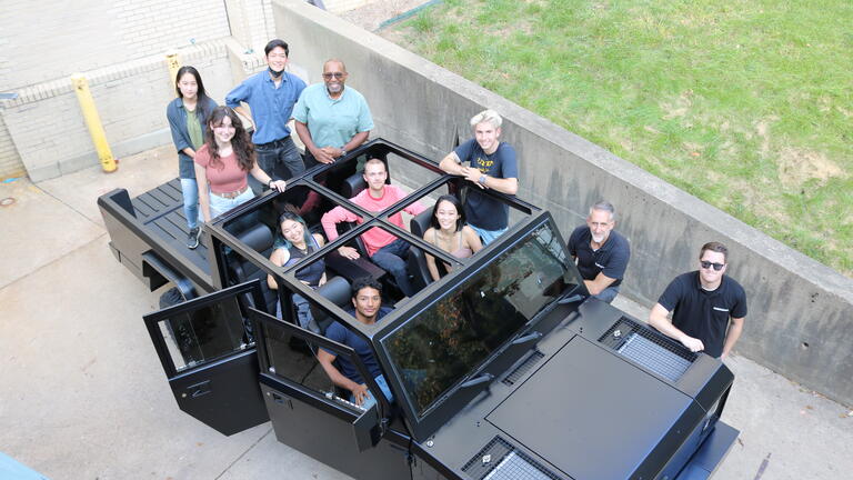 Products students posing in a Bollinger ruck