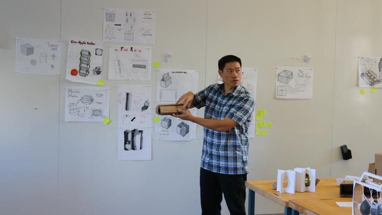Wayne Chung teaching in front of a studio