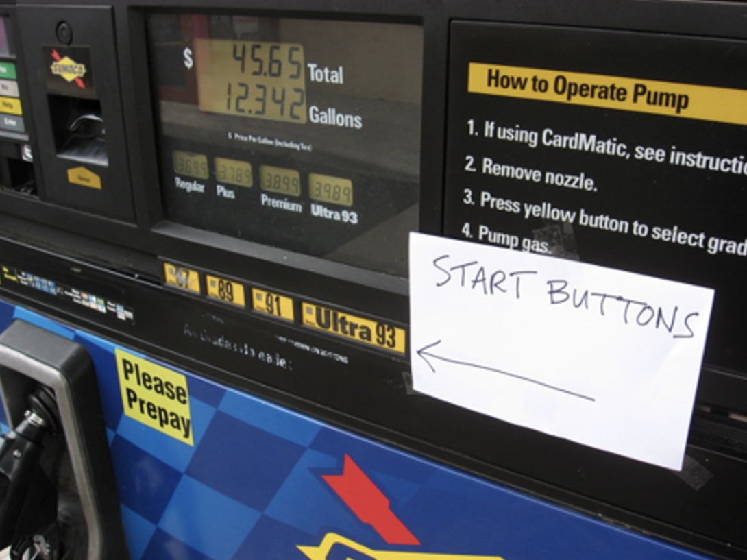 photograph of a hand written note that states "start buttons" with an arrow pointing to the fuel start buttons on a gas pump