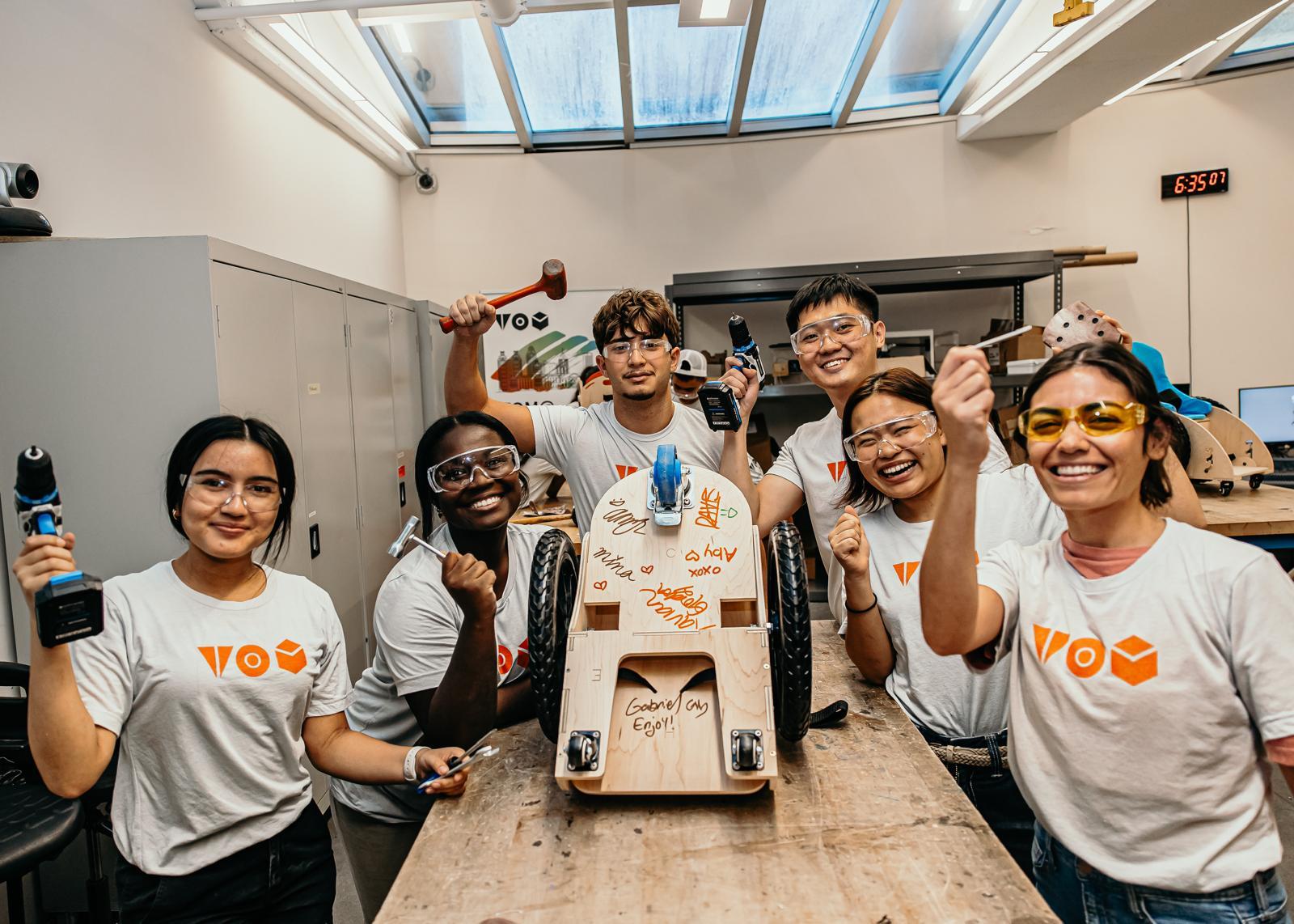 Students making a mobility scooter for a child