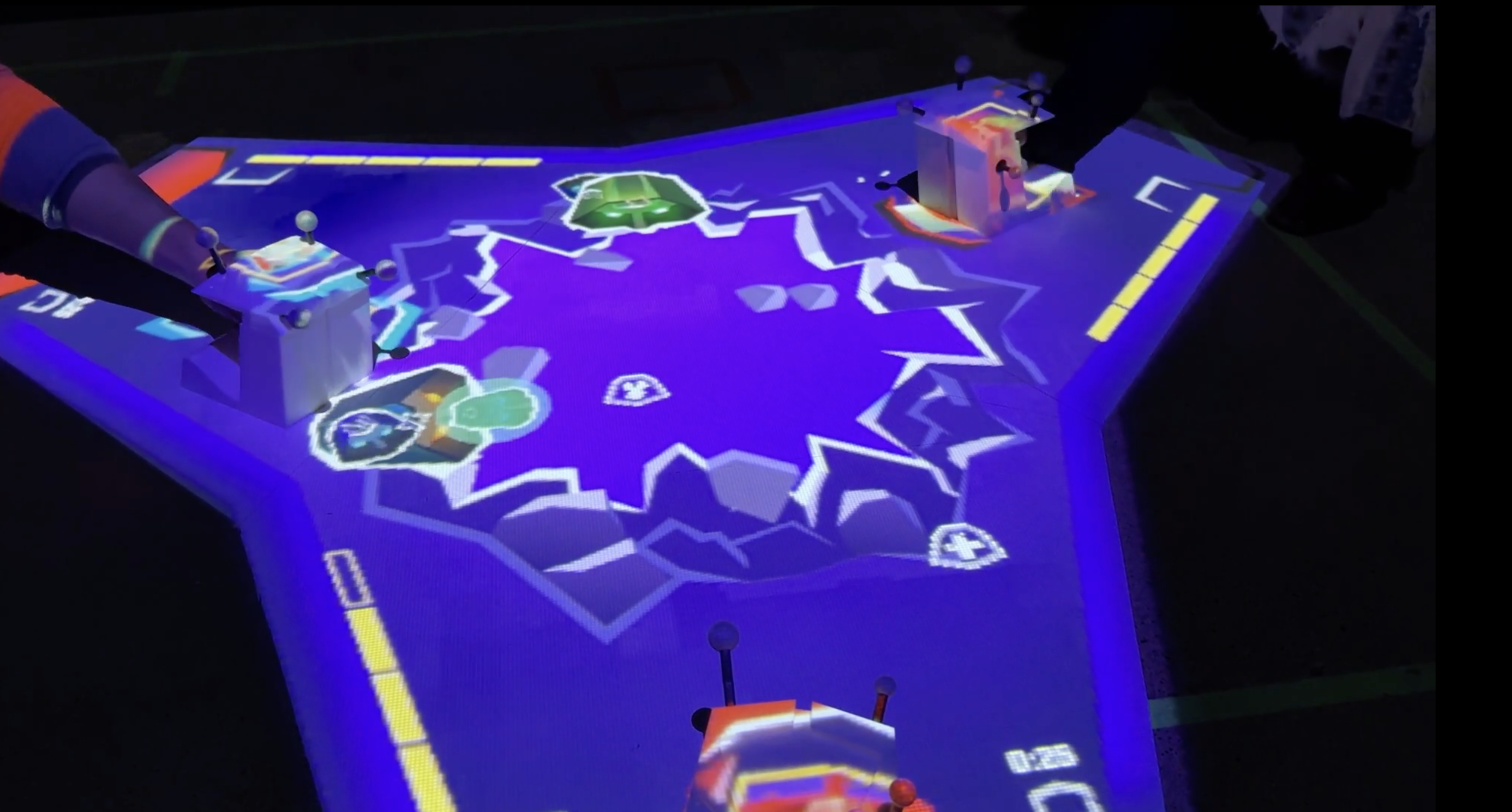 People playing a projected video game on a table