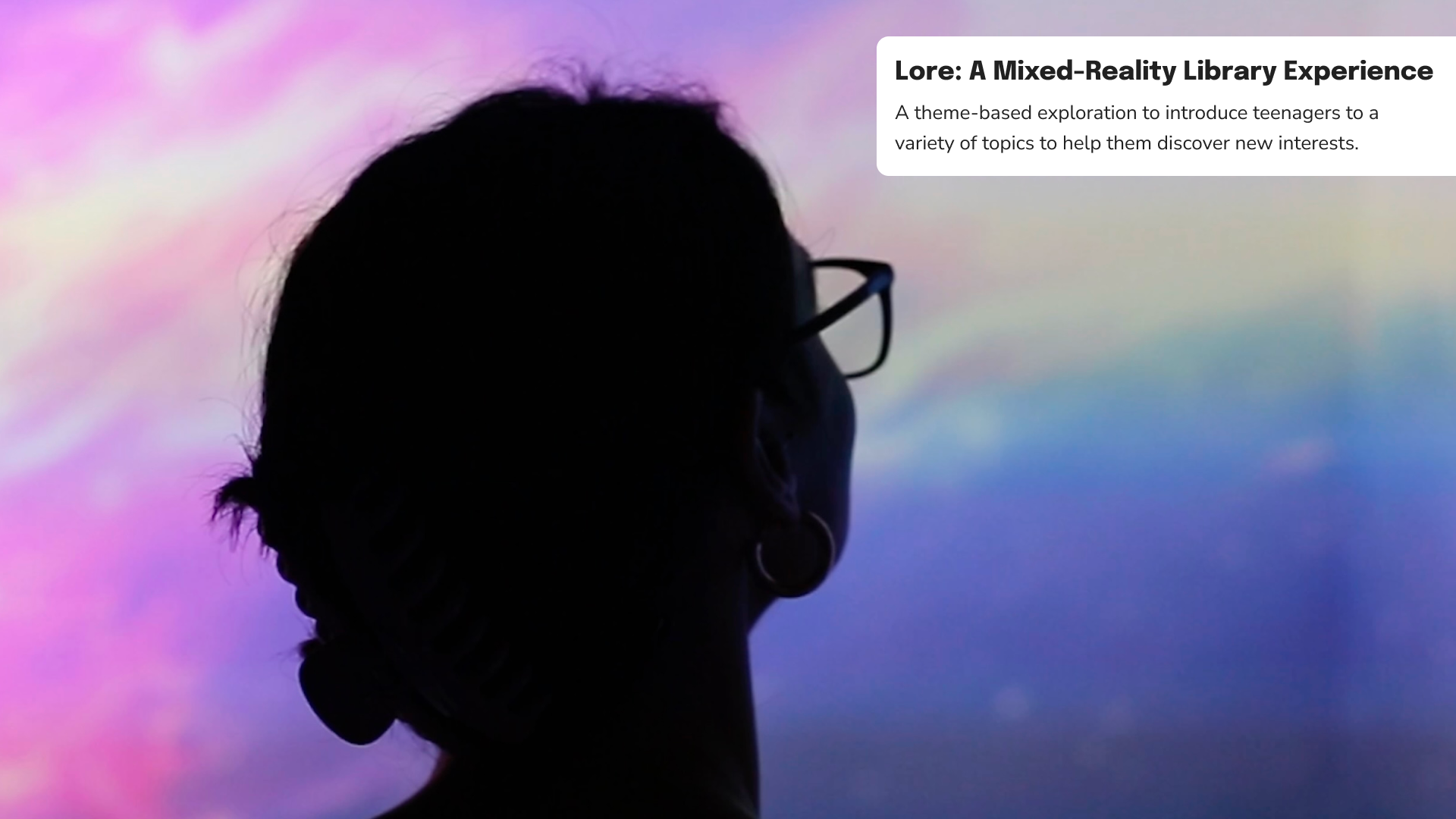 A woman standing against a projection.