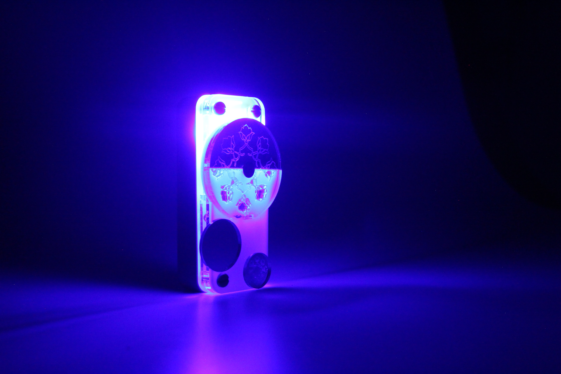 A blue flashlight with traditional Indian markings