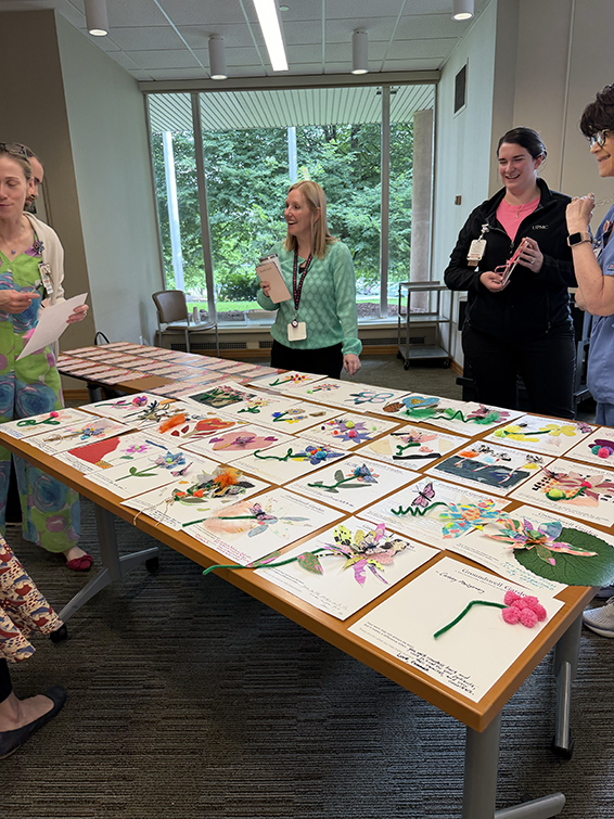 healthcare workers looking at their collages on a table