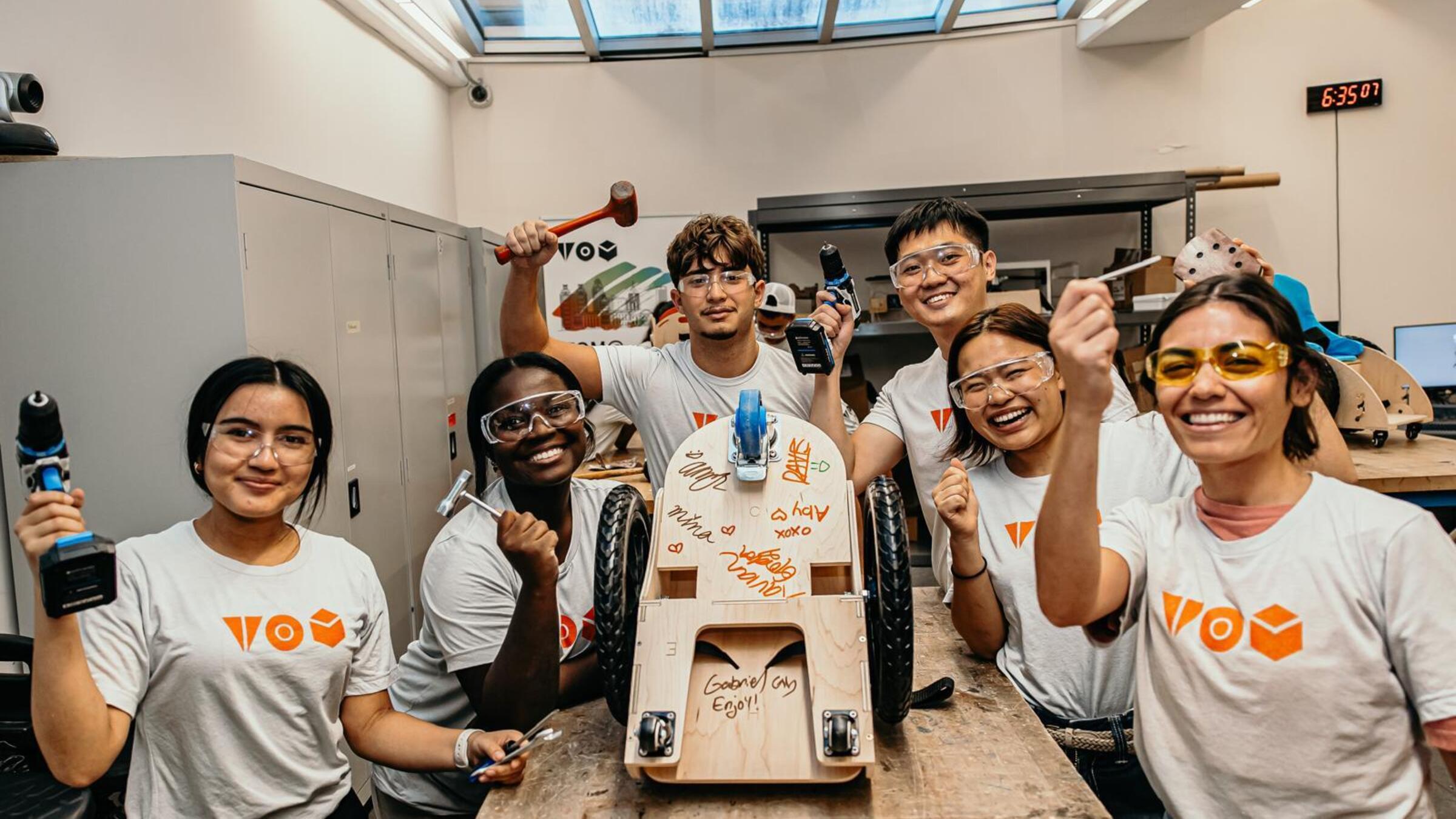 Students making a mobility scooter for a child