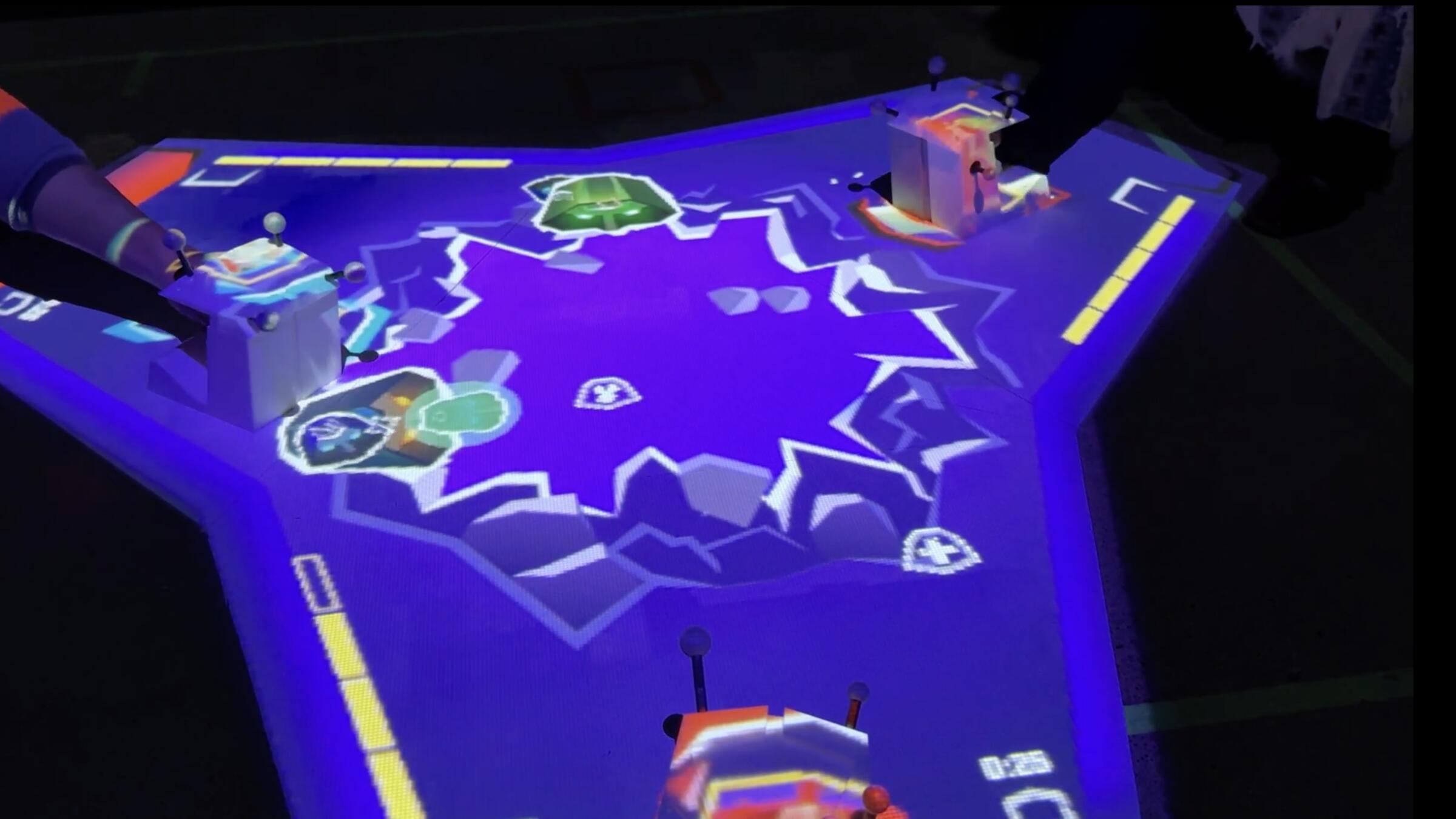 People playing a projected video game on a table