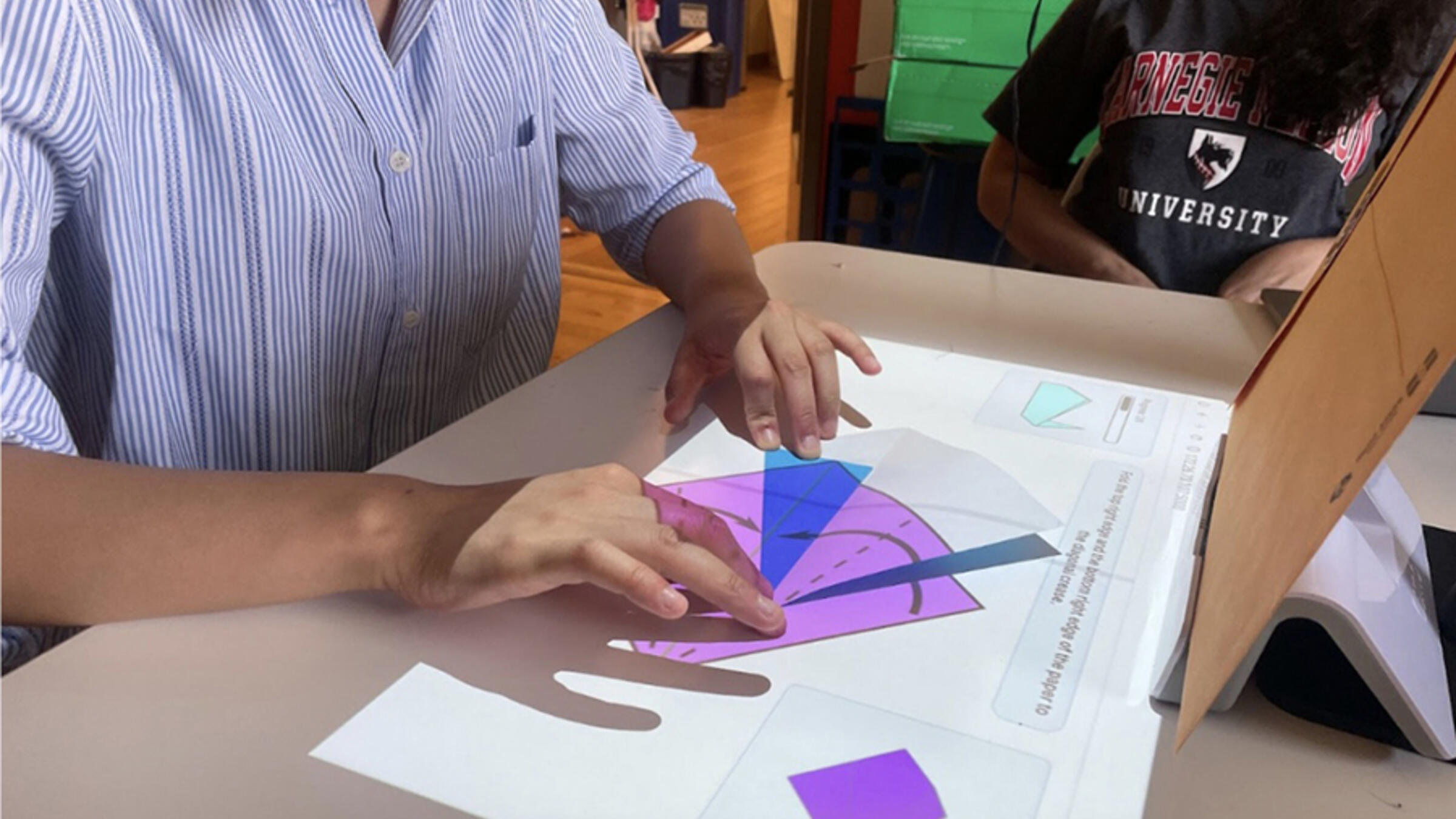 A mixed reality app teaching a user how to fold origami