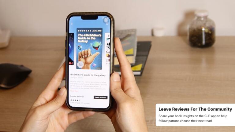 A person leaving a review for a book on their phone