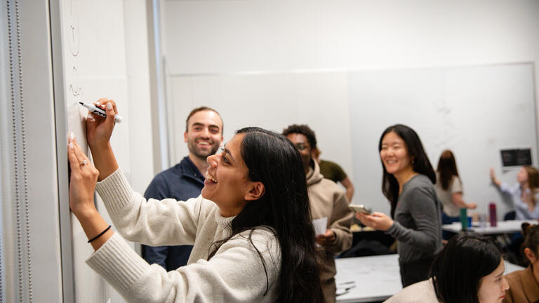 student draw diagrams at the whiteboard together