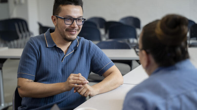 Luis Garcia speaking with a student