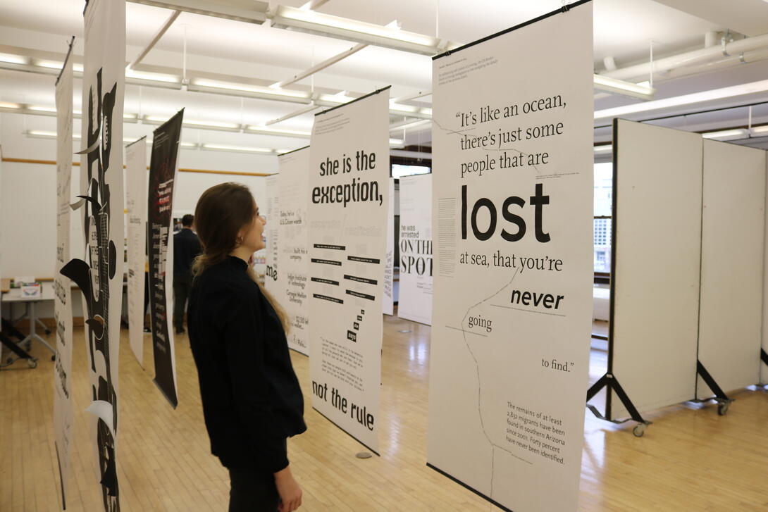 A student looking at a poster.