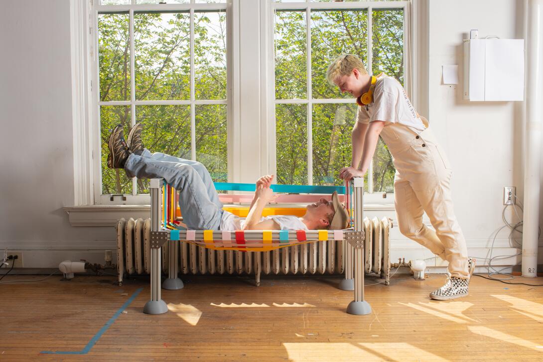 2 people sitting on a comfortable bench