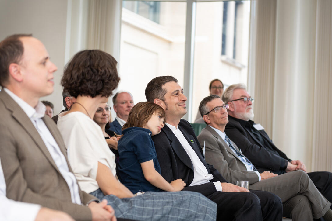 Peter Scupelli and his family sitting in an audience