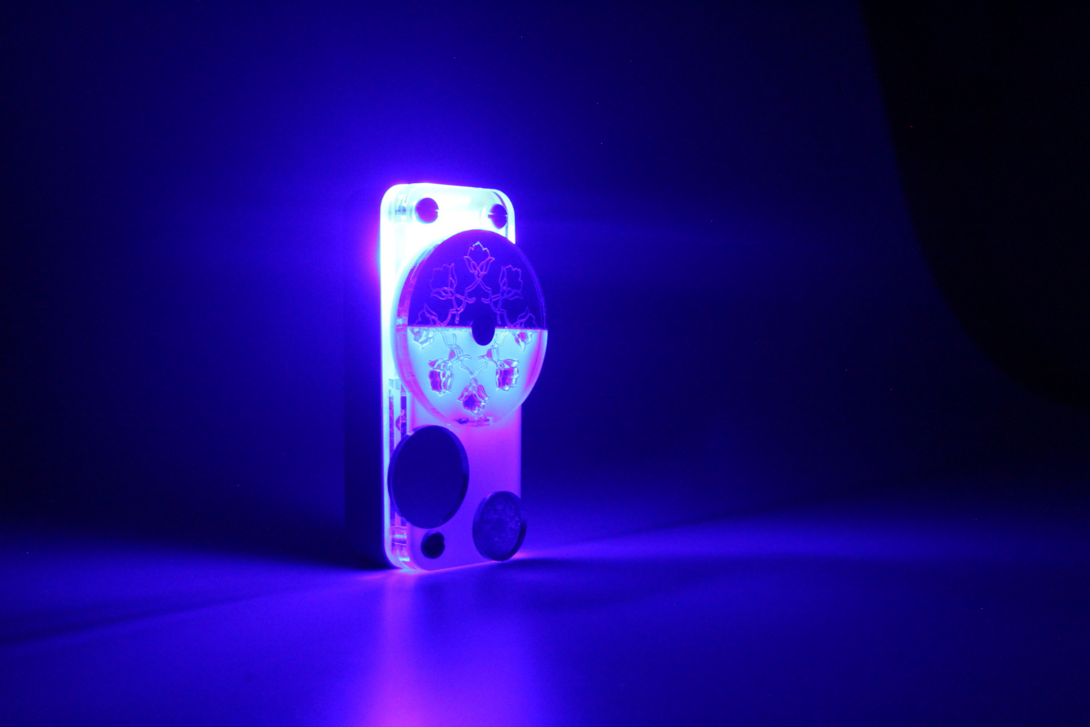 A blue flashlight with traditional Indian markings